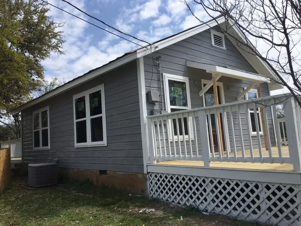 Front corner of the cottage after painting, gray siding and white trim