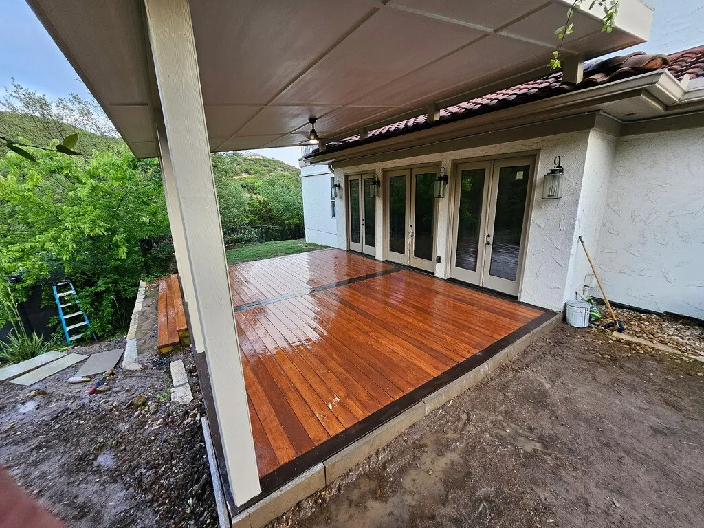 New stained wood deck under a painted patio cover