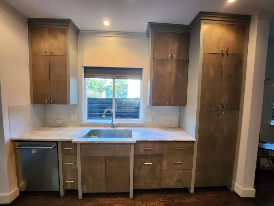 The same kitchen before, with dark brown stained cabinets
